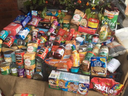 A variety of canned and packaged food items arranged on a table.